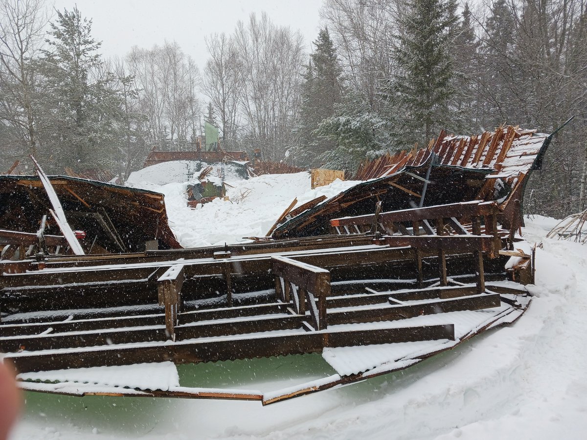 snow covered collapsed sawmill building